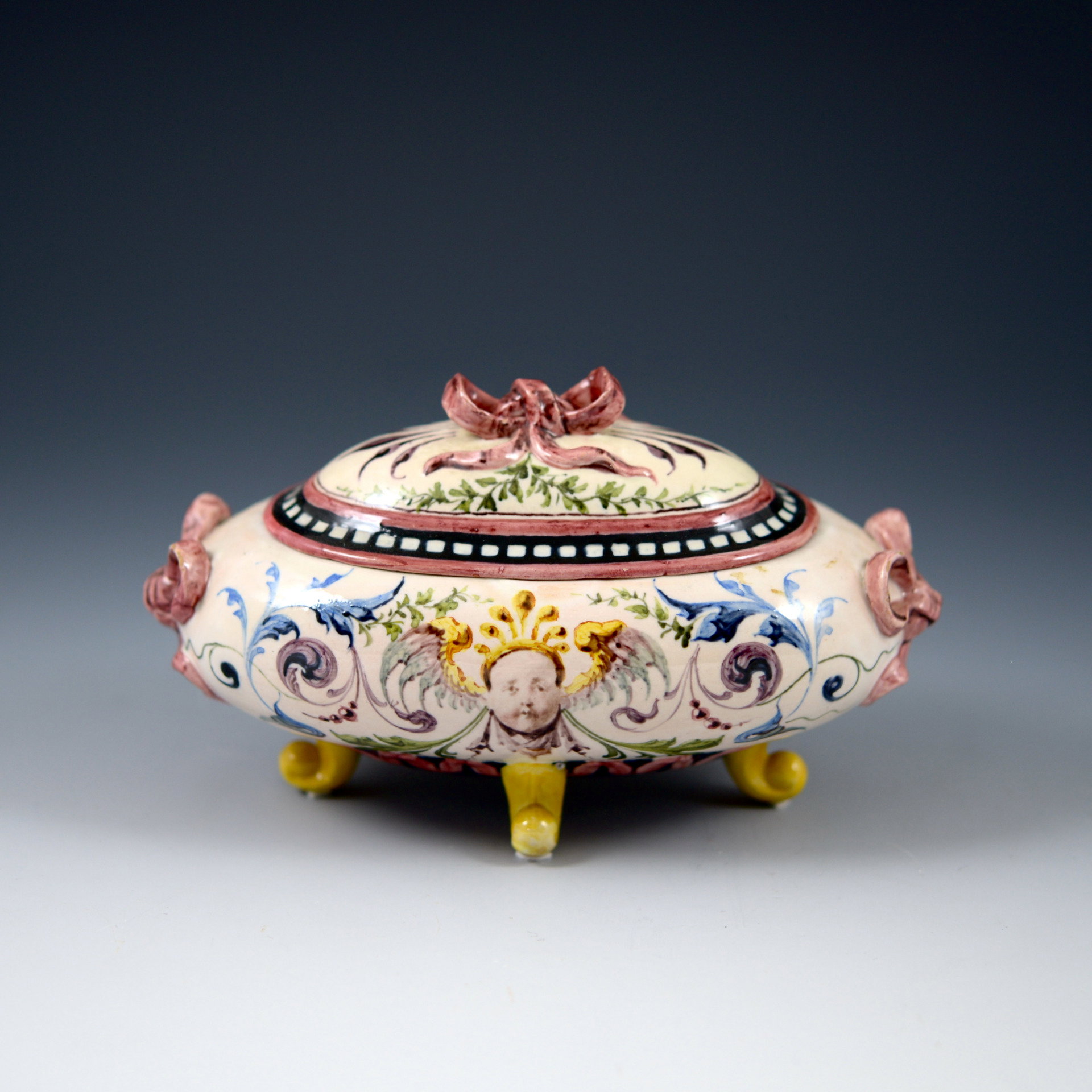 Jewelry box with ribbon-shaped handles and grotesque decorations